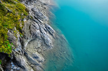 Turquoise water of Katun river surrounded by steep cliffs. Near the island Patmos in Altai mountains, Siberia, Russia