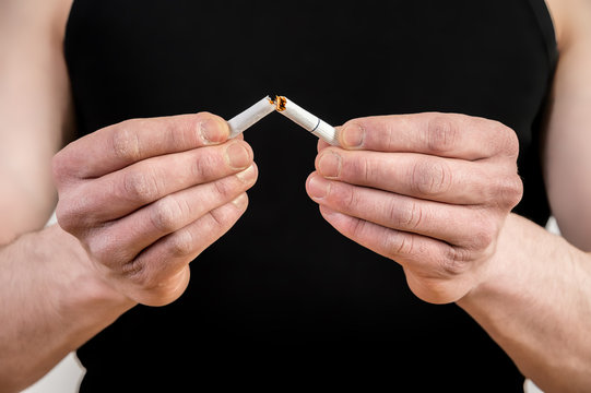 Quit smoking - male hand crushing cigarette