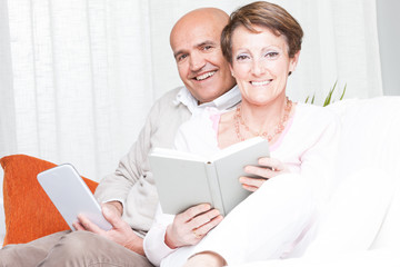 Loving happy couple relaxing reading at home