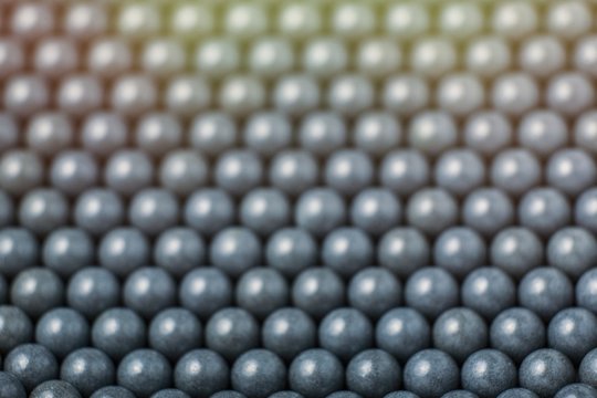 blurred background of grey airsoft balls of 6mm © Vasiliy