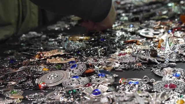 Various silver jewelry. Jewelry and decorative metal buckles. Close up view.