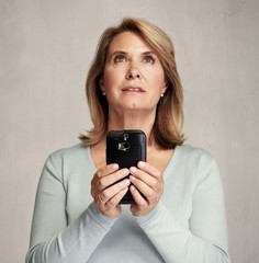 thinking woman with smartphone