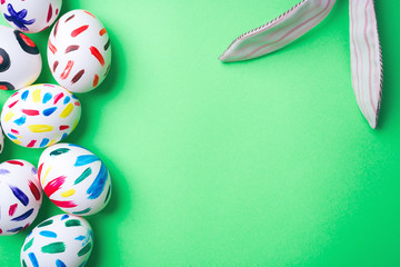 Easter eggs in a green background. Easter bunny. Rabbit. Easter ideas. Easter eggs. Space for text.