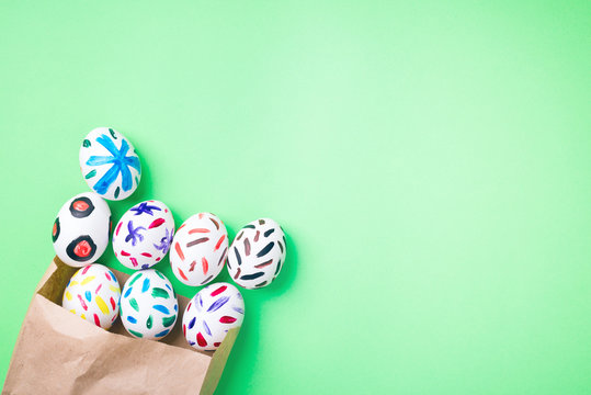 Easter eggs in a paper bag. Green background. Easter ideas. Easter eggs. Space for text.