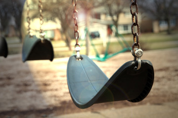 Empty Swings in a  light.