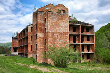 Unfinished brick building in Carpathian mountains. Summer