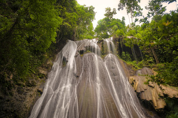Fototapeta premium Batanta Island Waterfall, Indonesia. After a one hour hike through rain forest you come to spectacular 60+ meter waterfall located on Batanta Island in the Raja Ampat area of West Papua, Indonesia. 