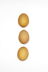 Row made of three brown eggs.