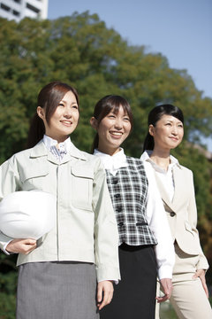 Businesswomen standing in a row smiling