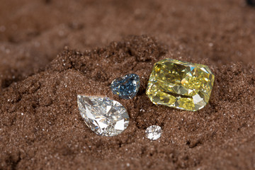 Beautiful loose diamonds different shape on the sand