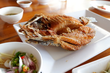 Fried fish on plate with sauce