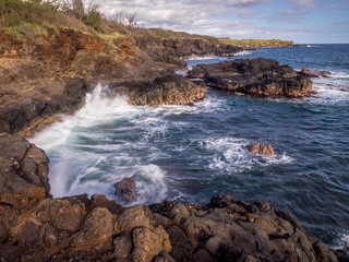 Lava rock off stunning glass beach near Port Allen town on Kauai Hawaii.