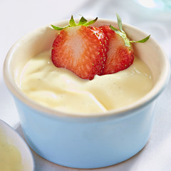 Vanilla custard dessert with fresh strawberries