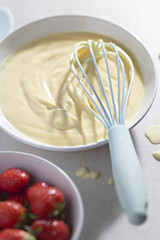 Vanilla custard dessert with fresh strawberries
