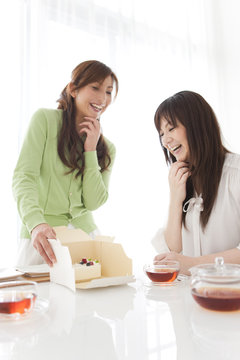 Mid Adult Women Having Cake and Tea