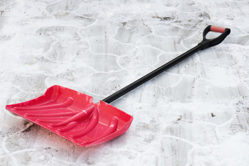 Red plastic shovel for snow removal. Winter concept.