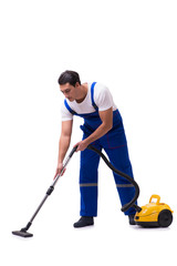Man in coveralls doing vacuum cleaning on white