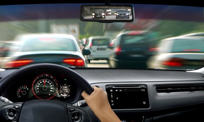 Hand on steering wheel during traffic jam