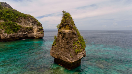 Fototapeta premium Aerial view of a cliff in the sea on the Suwehan beach. Nusa Penida, Indonesia.