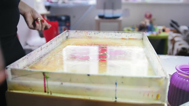Process of painting red spots on water - Liquid Ebru art technics