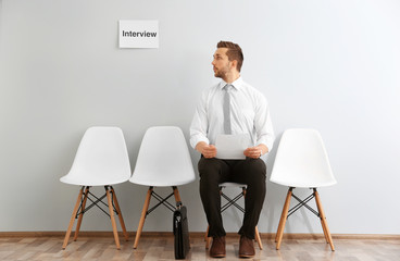 Young man waiting for interview indoors