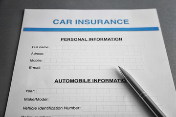 Car insurance form and pen on table