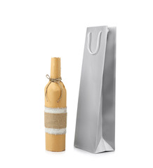 Wine bottle and gift bag on white background