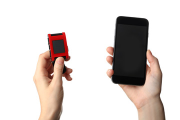 Female hands with heart rate monitor watch and smart phone on white background