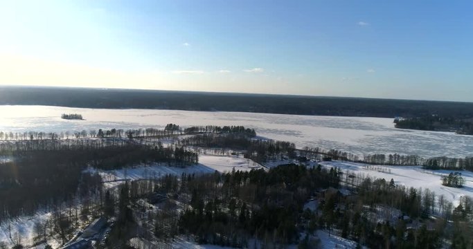 Bodom lake, Cinema 4k aerial landing view of a golf course and Bodom mansion, on a sunny and snowy winter day, in Espoo, Finland