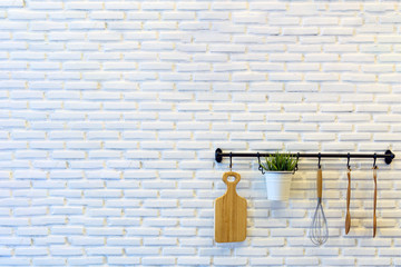 Kitchen Tools hang on the white brick wall