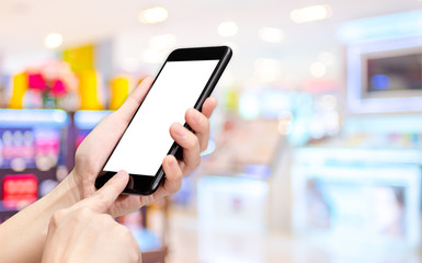 Hand click mobile phone with blur department store background bokeh light,White screen mock up template for adding your design or your text