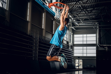 Black basketball player in action in a basketball court.