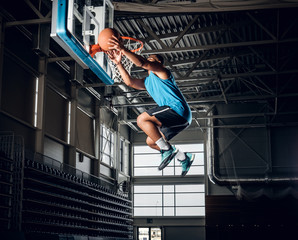  Black basketball player in action in a basketball court.