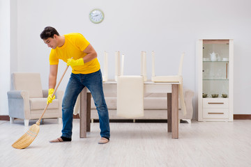 Man husband cleaning the house helping his wife