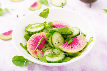 Fresh salad of cucumbers, watermelon radishes and arugula