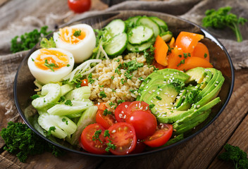 Diet menu. Healthy lifestyle. Bulgur porridge, egg and fresh vegetables - tomatoes, cucumber, celery and avocado on plate.