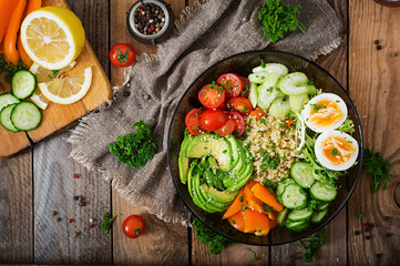 Diet menu. Healthy lifestyle. Bulgur porridge, egg and fresh vegetables - tomatoes, cucumber, celery and avocado on plate. Top view. Flat  lay.