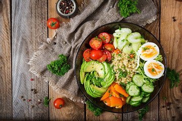 Diet menu. Healthy lifestyle. Bulgur porridge, egg and fresh vegetables - tomatoes, cucumber, celery and avocado on plate. Top view. Flat  lay.