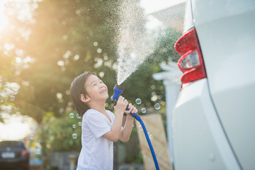 Asian children washing car