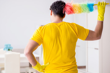 Man husband cleaning the house helping his wife