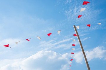 Old triangle flags hung across the  blue sky.