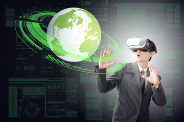 Smart business man in very exciting mood with VR headset with globe and digital ring on digital background. Head-up Display concept.Elements of this image are furnished by NASA