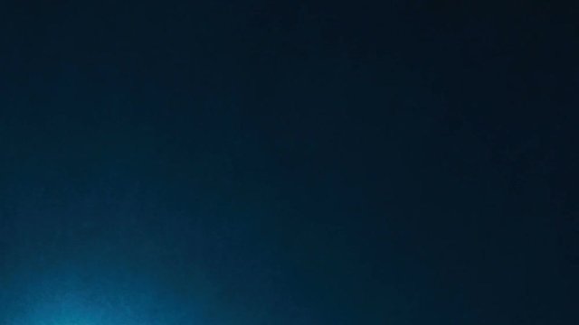 Searchlight tower on a dark sky background. Mast with spotlights illuminate on stadium and night sky background. Multiple sport light. A mast with a searchlight in a sports stadium.