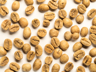 top view of white coffee beans on white background