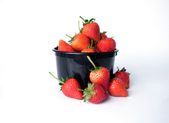 black bowl with strawberries isolated on white background