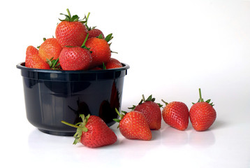 black bowl with strawberries isolated on white background
