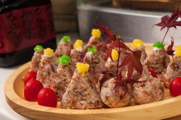 Japanese rice ball onigiri on wooden plate