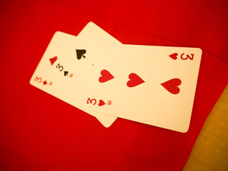 Playing cards on red table