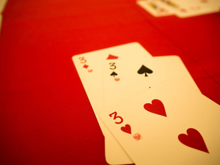 Playing cards on red table