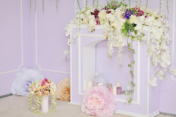 Fireplace decorated with flowers.